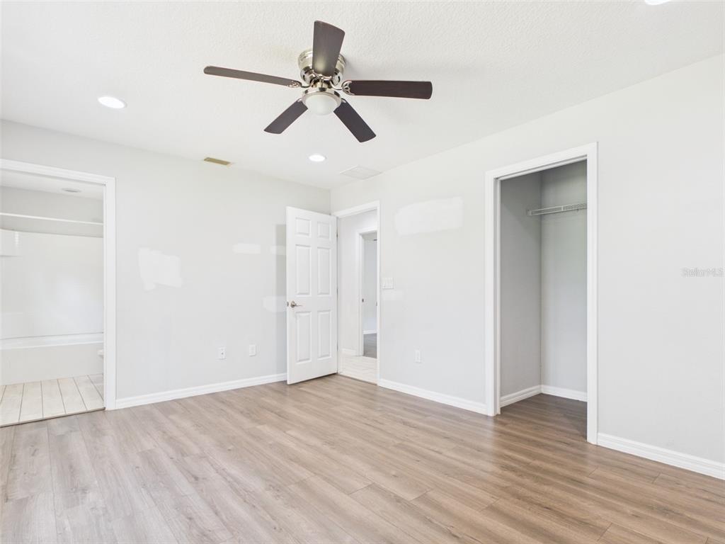 4309 Southwest 143rd Ln Road Ocala, FL 34473 - Photo 17 of 21 a view of a room with wooden floor and ceiling fan