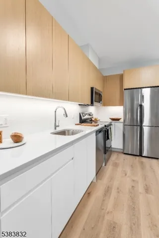a kitchen with a sink a refrigerator and a stove