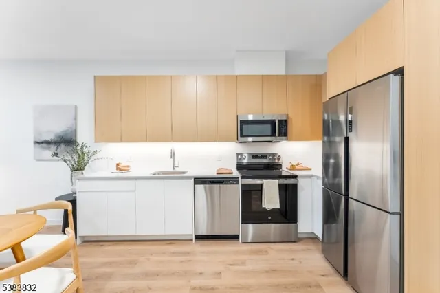 a kitchen with stainless steel appliances granite countertop a refrigerator and a stove top oven