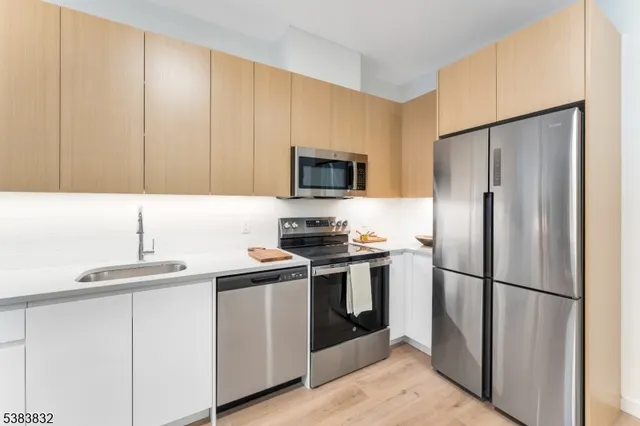 a kitchen with a sink stove and refrigerator
