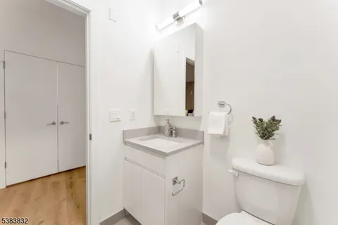 a bathroom with a sink a toilet and mirror