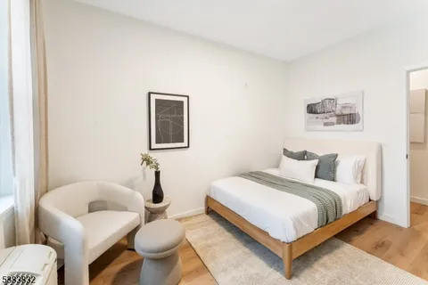 a bedroom with a bed and glass wall