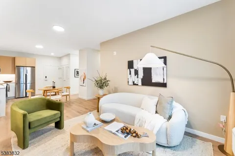 a living room with furniture and a chandelier