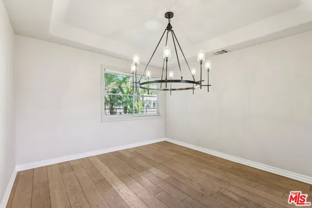 a view of a kitchen with wooden floor and a kitchen