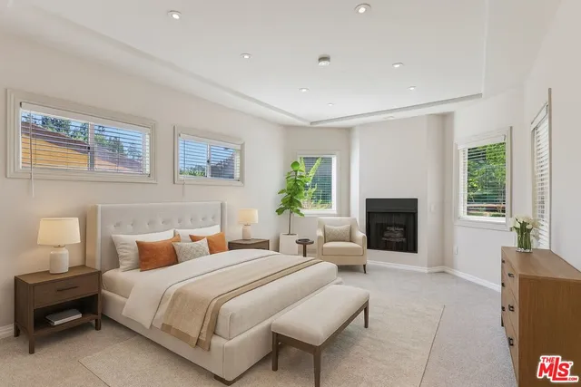 a view of an empty room with a fireplace and a window