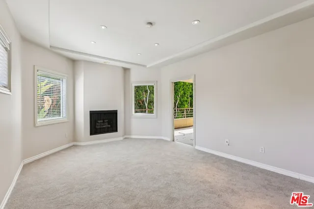 an empty room with a empty space and windows