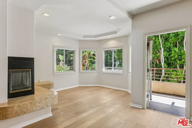 a view of a livingroom with an empty space and a fireplace