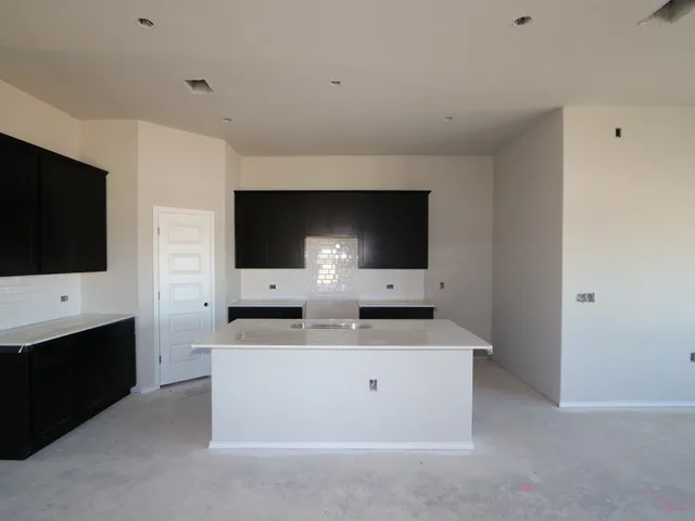 a spacious bathroom with a sink and a large mirror