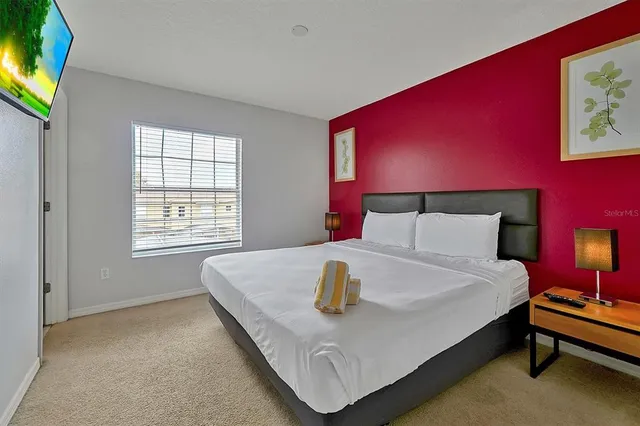 a bedroom with a bed and a lamp