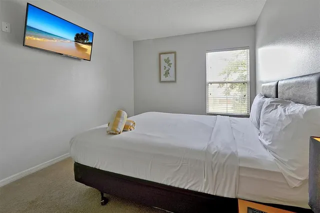 a bedroom with bed and window