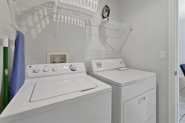 a view of a balcony with furniture and an umbrella