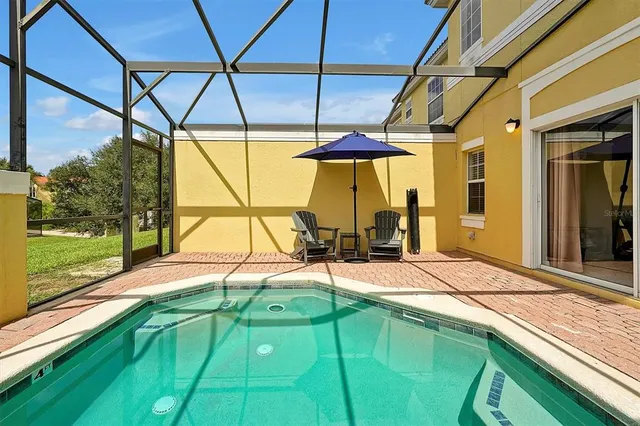 a view of a house with a backyard and sitting area