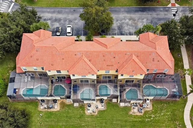 a view of patio with chairs and table under an umbrella