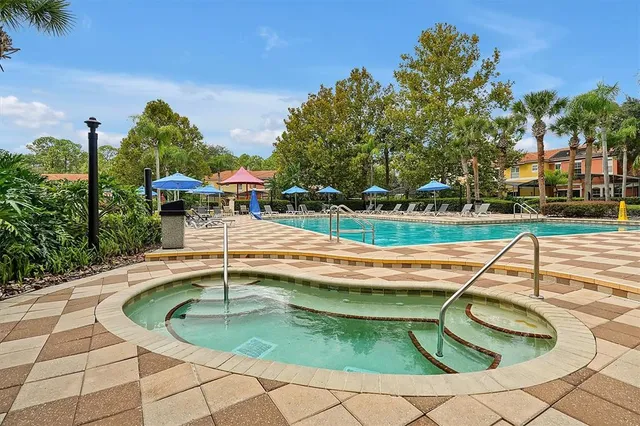 an aerial view of residential houses with outdoor space and river