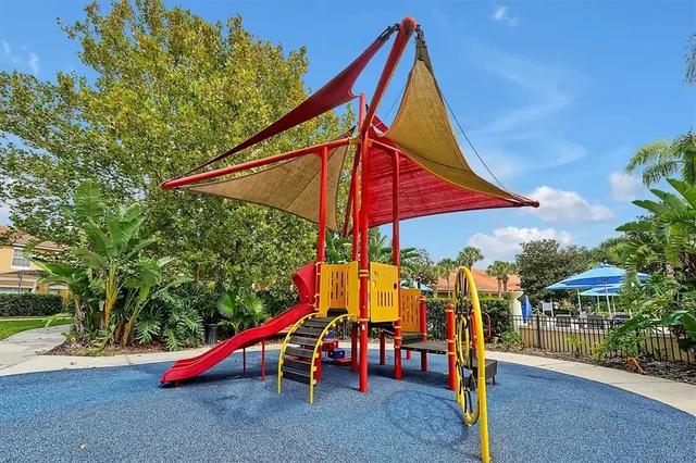 an aerial view of a city with lots of residential buildings ocean and mountain view in back