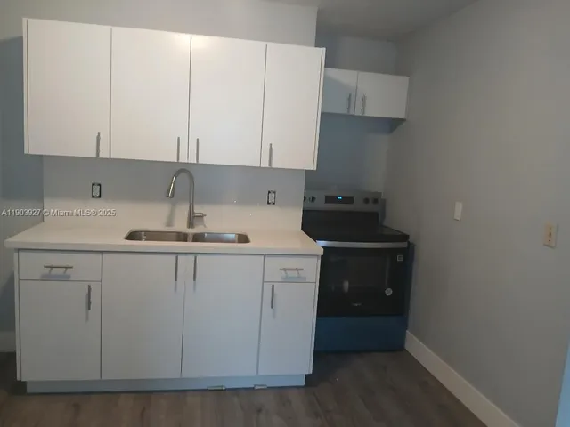 a kitchen with a sink and cabinets