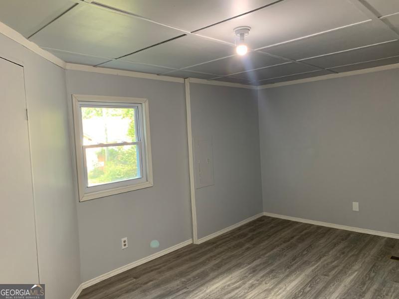 342 Phillips Circle Royston, GA 30662 - Photo 13 of 23 an empty room with wooden floor and windows