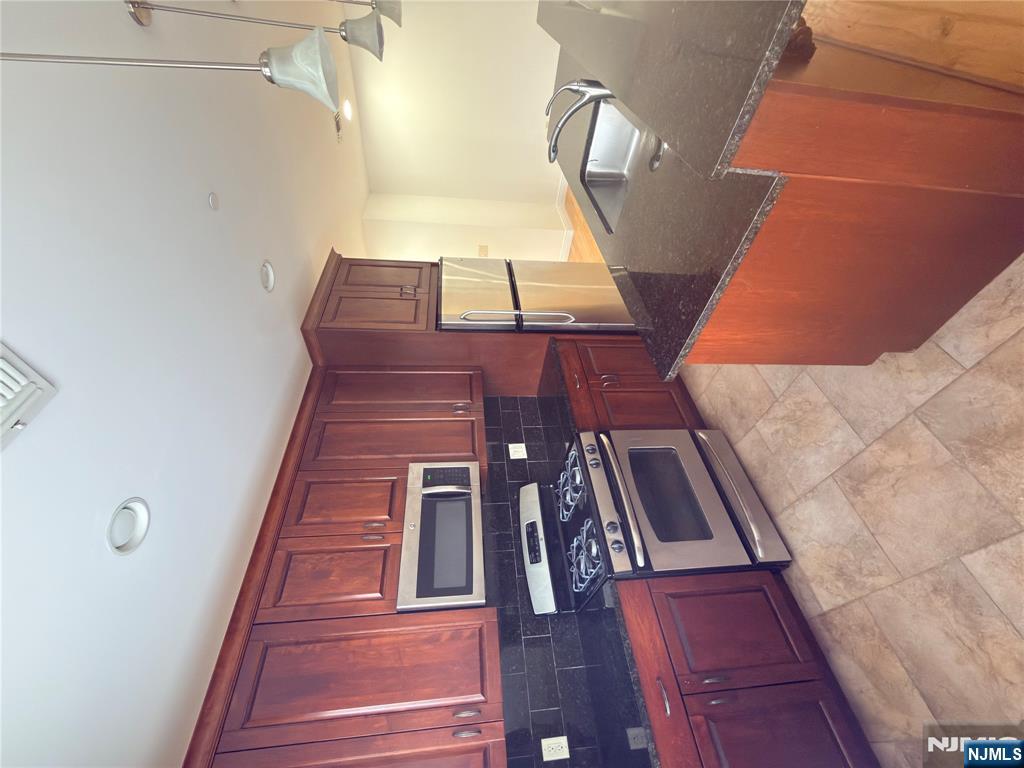 725 River Road, Unit 1B New Milford, NJ 07646 - Photo 4 of 9 a kitchen with stainless steel appliances granite countertop a stove a sink dishwasher and a refrigerator