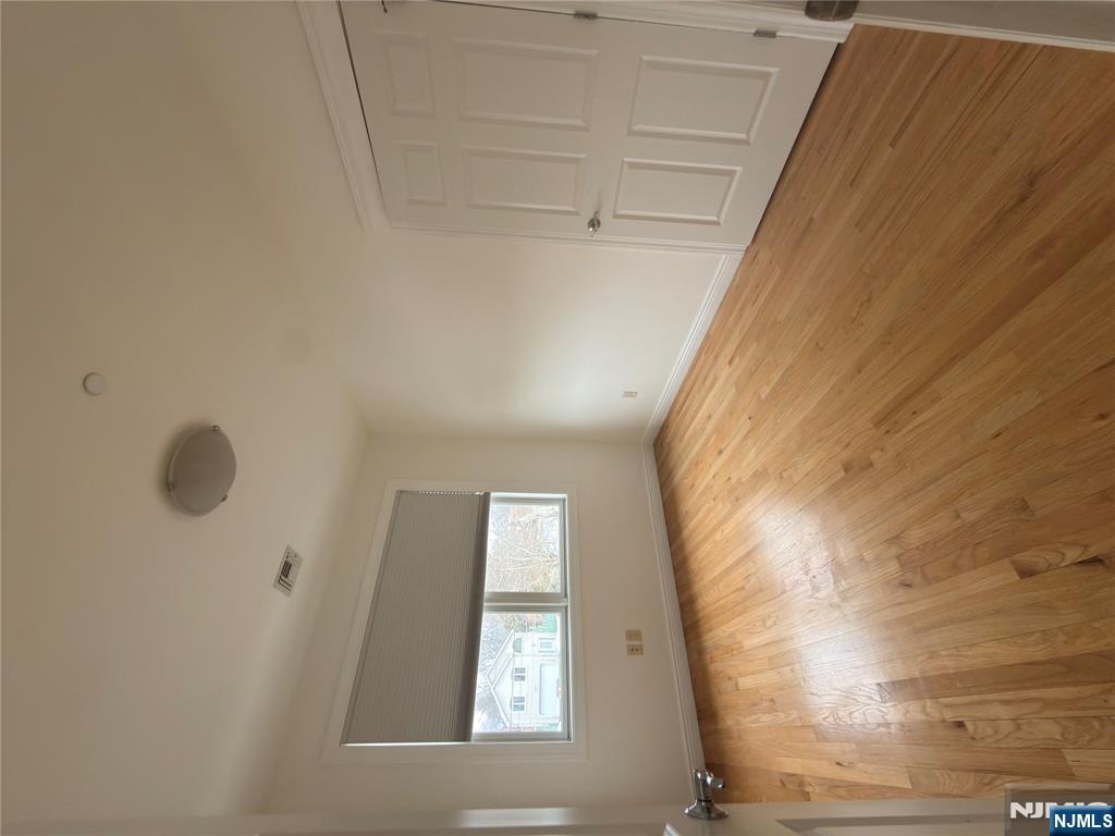 725 River Road, Unit 1B New Milford, NJ 07646 - Photo 6 of 9 an empty room with wooden floor and windows