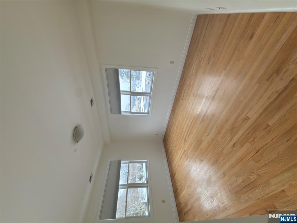 725 River Road, Unit 1B New Milford, NJ 07646 - Photo 7 of 9 wooden floor in an empty room with a window