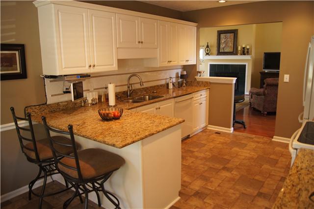 233 Savannah Ridge Murfreesboro, TN 37127 - Photo 6 of 20 Large eat in kitchen with granite countertops and tile backsplash