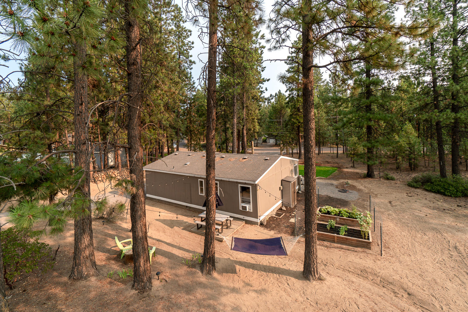 19197 Kiowa Road Bend, OR 97702 - Photo 12 of 32 a table and chairs sitting in the middle of a yard