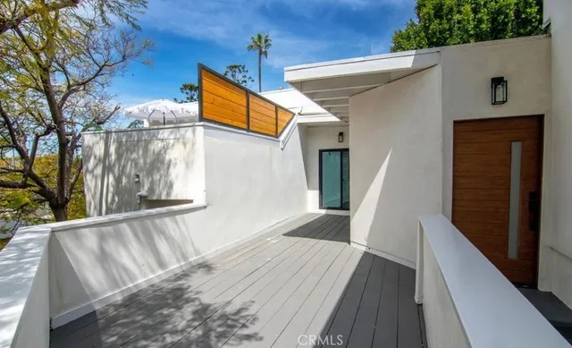 a view of balcony with wooden floor and fence