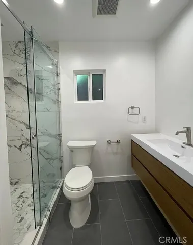 a bathroom with a toilet sink and shower