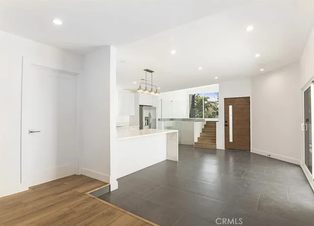 a view of a kitchen with a sink and refrigerator