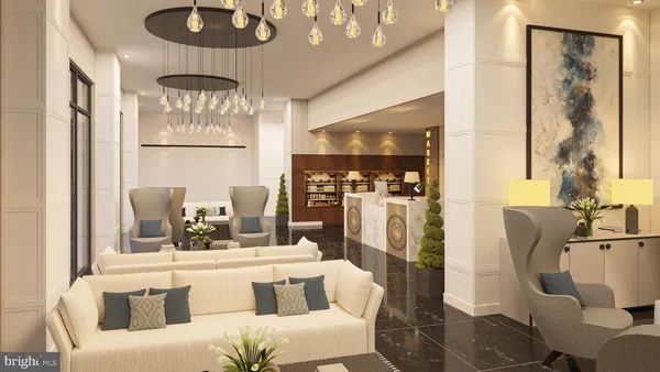 a living room with furniture a chandelier and a large mirror