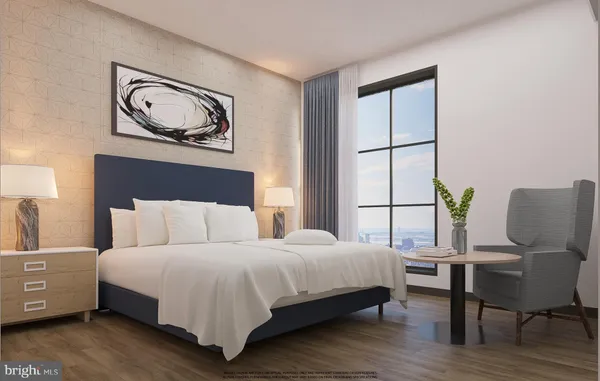 a bedroom with a large bed and a chair