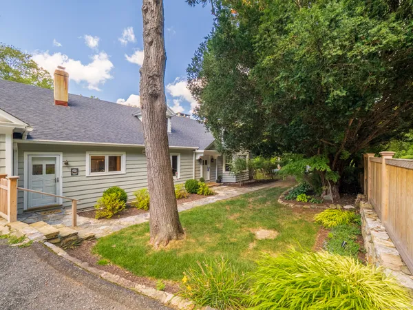 a front view of a house with a yard and porch