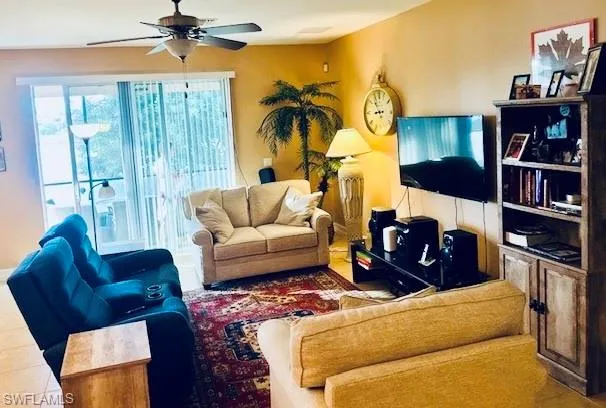 a living room with furniture a rug and a chandelier