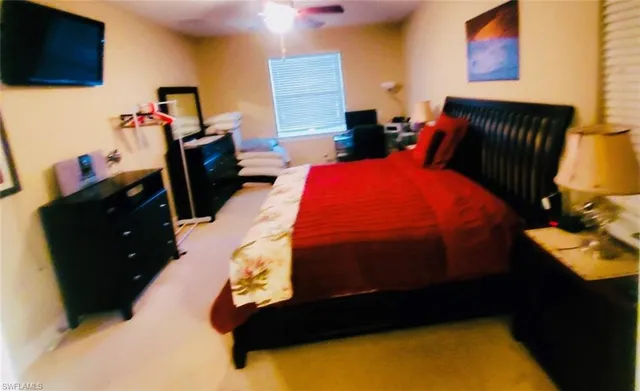a bedroom with a bed and flat screen tv