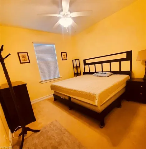 a large bed sitting in a bedroom next to a window