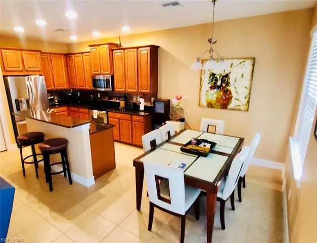 a dining room with furniture and a floor to ceiling window