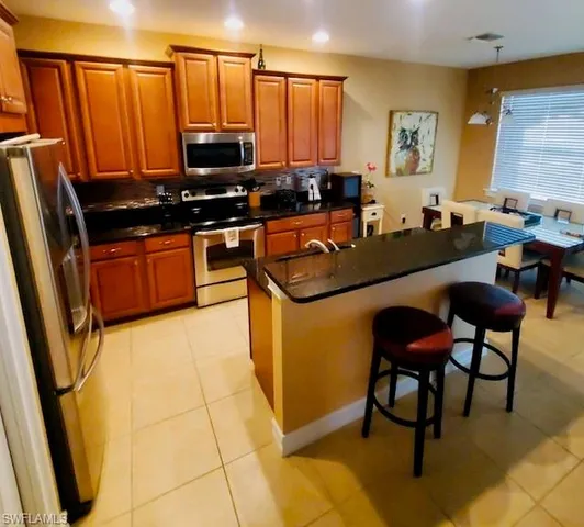 a kitchen with stainless steel appliances a stove a sink a counter top space and cabinets