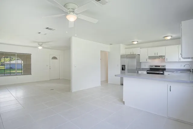 a view of kitchen with stainless steel appliances cabinets a sink and a counter top space