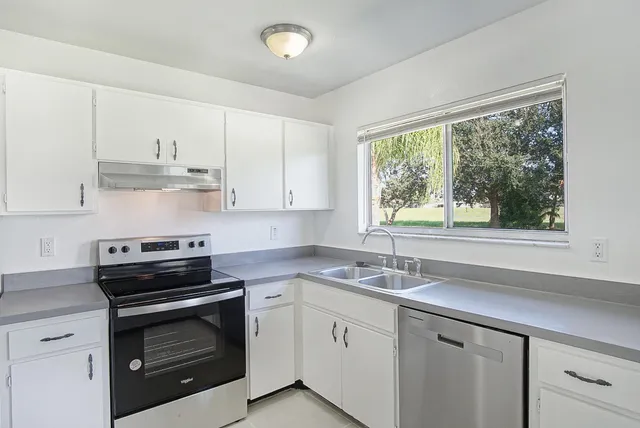 a kitchen with appliances cabinets and a sink
