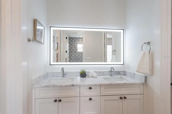 a bathroom with a granite countertop sink a toilet and shower