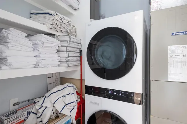 a view of a livingroom with furniture and floor to ceiling window