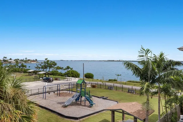 a front view of a house with a yard and potted plants