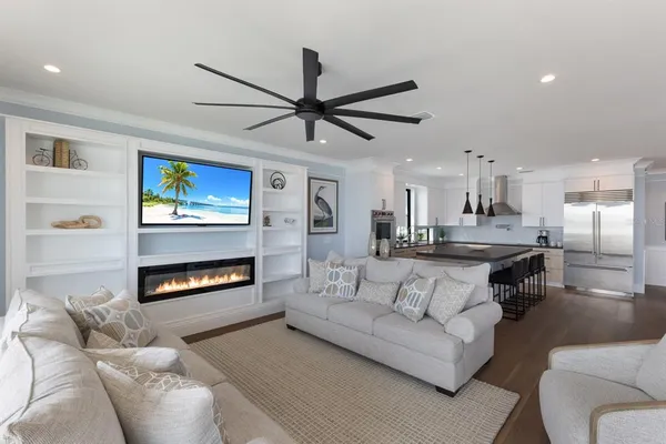 a kitchen with a refrigerator and white cabinets