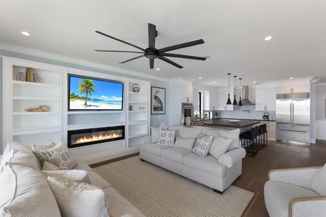 a kitchen with a refrigerator and white cabinets