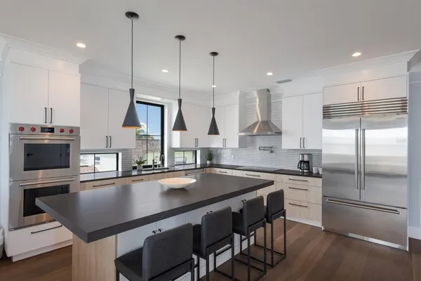 a kitchen with stainless steel appliances a sink and cabinets
