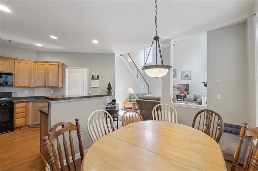 2747 High Creek Run Dacula, GA 30019 - Photo 21 of 48 a kitchen with stainless steel appliances granite countertop a kitchen island hardwood floor and a sink