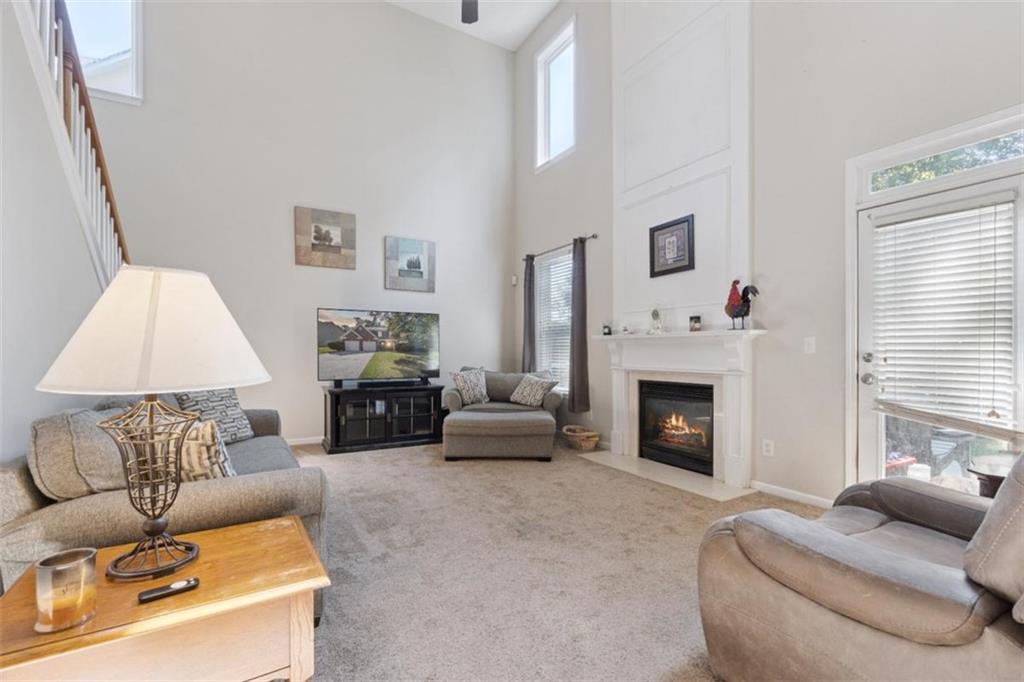 2747 High Creek Run Dacula, GA 30019 - Photo 24 of 48 a living room with furniture and a fireplace