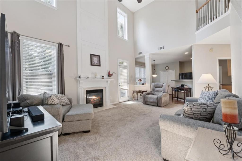 2747 High Creek Run Dacula, GA 30019 - Photo 25 of 48 a living room with furniture and a fireplace