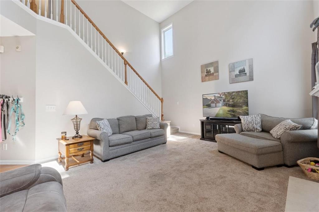 2747 High Creek Run Dacula, GA 30019 - Photo 27 of 48 a living room with furniture and a lamp
