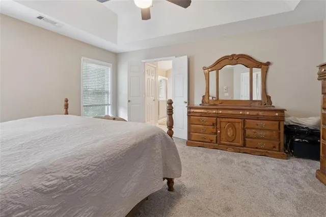 a spacious bedroom with a bed and window